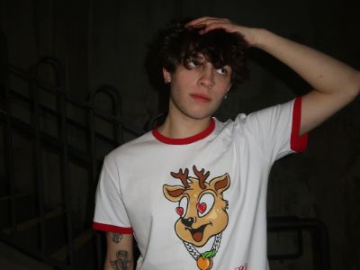 Nicolas Sturniolo is wearing a white shirt with deer on it.